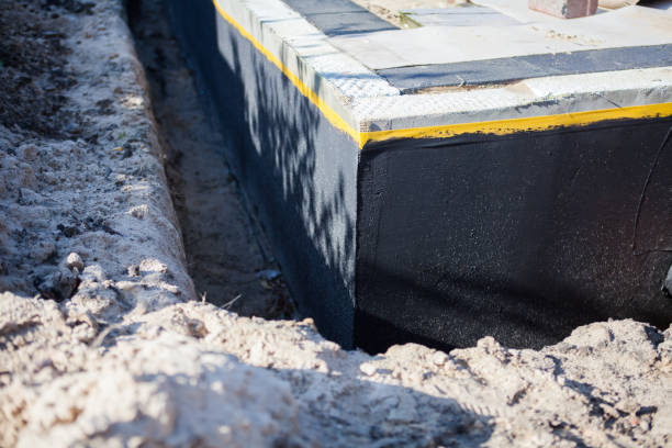 Professional Waterproofing technician working in Raymond, KS